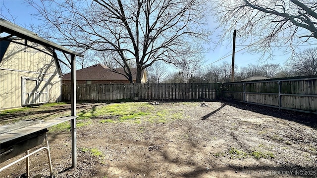 view of yard with an outbuilding, a barn, and fence