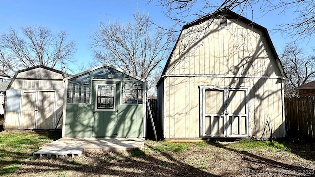 view of shed featuring fence