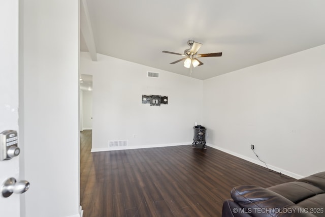 living area featuring baseboards, wood finished floors, visible vents, and ceiling fan