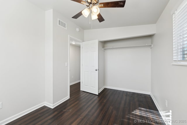 unfurnished bedroom featuring visible vents, ceiling fan, baseboards, a closet, and dark wood-style floors