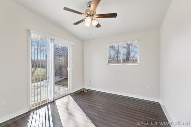 unfurnished room featuring plenty of natural light, dark wood-type flooring, a ceiling fan, and vaulted ceiling