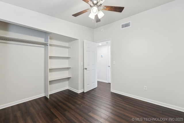 unfurnished bedroom featuring visible vents, baseboards, a closet, and dark wood finished floors