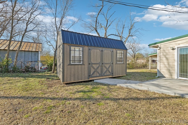 view of shed featuring fence