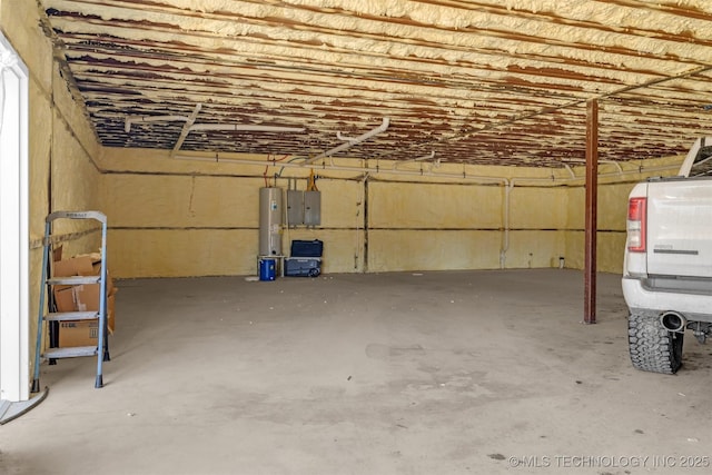 garage featuring electric panel and water heater