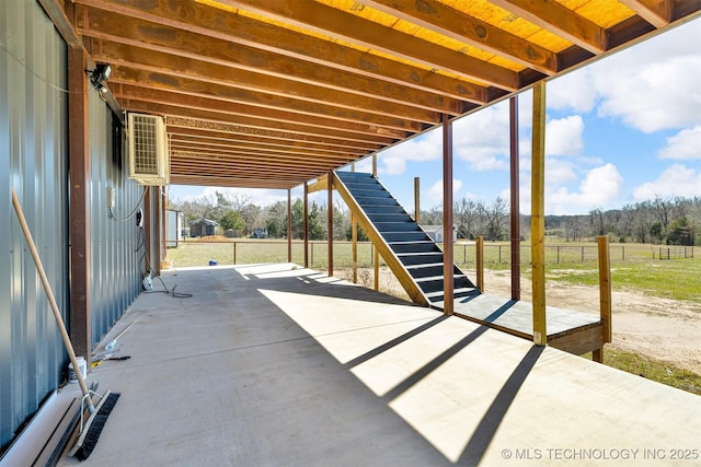 view of patio featuring a rural view and stairway