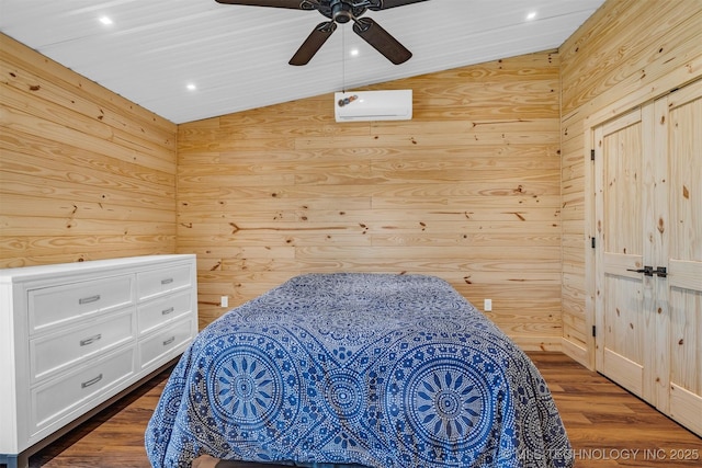 bedroom featuring wooden walls, ceiling fan, lofted ceiling, and wood finished floors