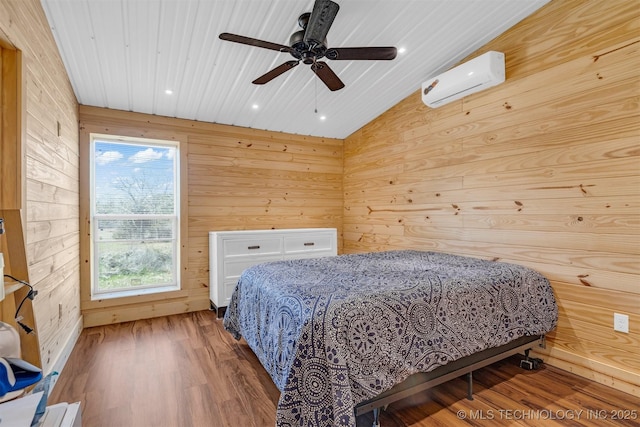 bedroom with wooden walls, wood ceiling, vaulted ceiling, wood finished floors, and a wall mounted AC