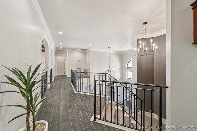 hall with dark wood finished floors, a notable chandelier, recessed lighting, and baseboards