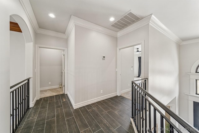 hall with visible vents, crown molding, baseboards, recessed lighting, and wood finished floors