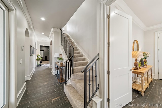 interior space with recessed lighting, arched walkways, crown molding, baseboards, and wood tiled floor