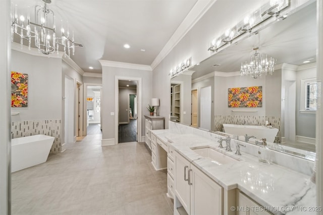 full bath featuring vanity, a soaking tub, and ornamental molding