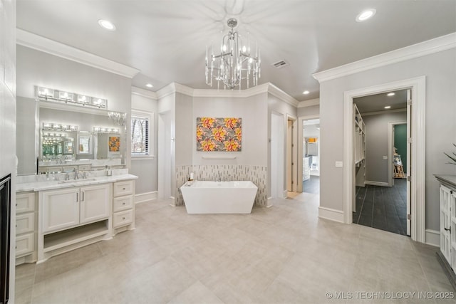 bathroom with a freestanding tub, visible vents, a notable chandelier, recessed lighting, and vanity