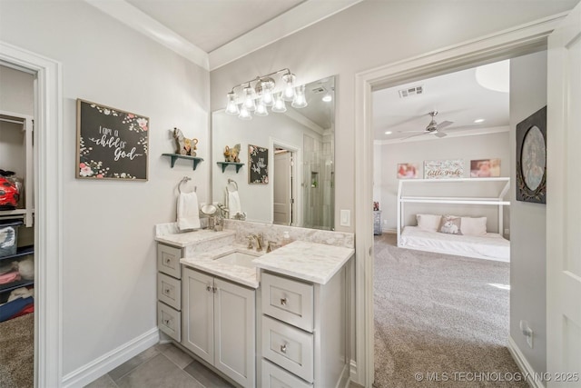 bathroom featuring vanity, crown molding, baseboards, and ceiling fan