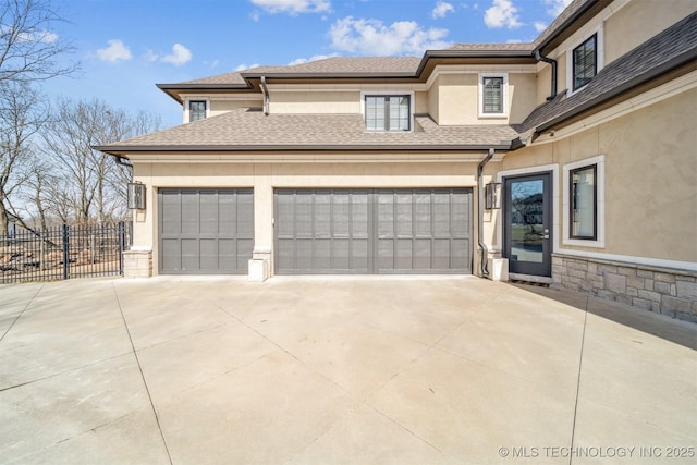 garage with fence and driveway