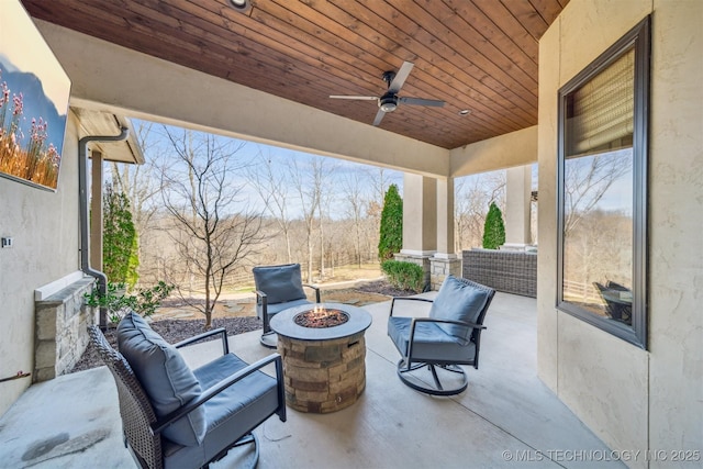 view of patio with an outdoor living space with a fire pit and ceiling fan