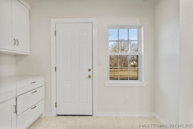 entryway featuring baseboards