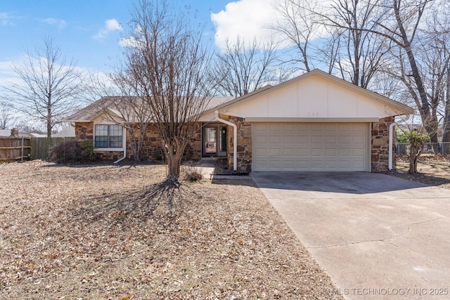 ranch-style home featuring stone siding, concrete driveway, a garage, and fence