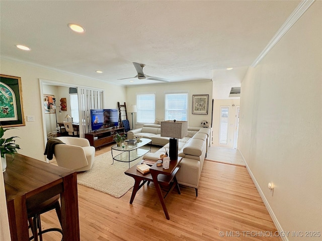 living room with recessed lighting, baseboards, crown molding, and light wood-style floors