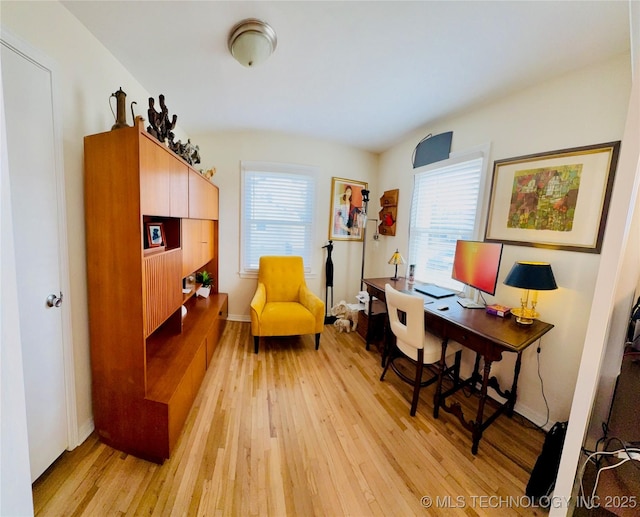 office area with baseboards and light wood finished floors