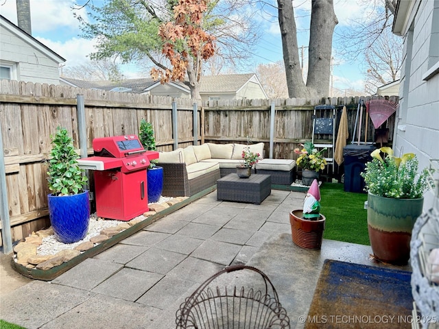 view of patio with grilling area, an outdoor hangout area, and a fenced backyard