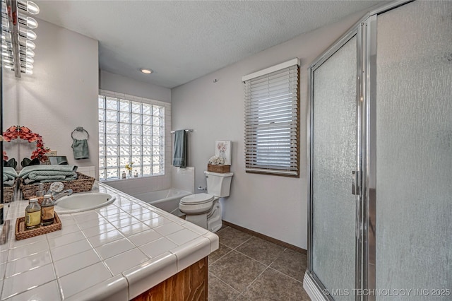 full bathroom with baseboards, a textured ceiling, a shower stall, and tile patterned flooring