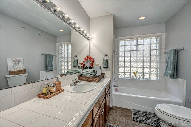 bathroom featuring tile patterned flooring, toilet, and vanity