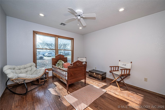 bedroom with visible vents, baseboards, hardwood / wood-style floors, recessed lighting, and a textured ceiling