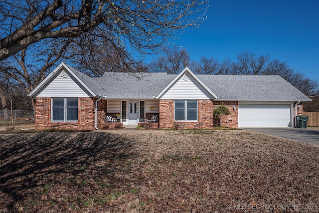 ranch-style house with brick siding, concrete driveway, roof with shingles, and fence