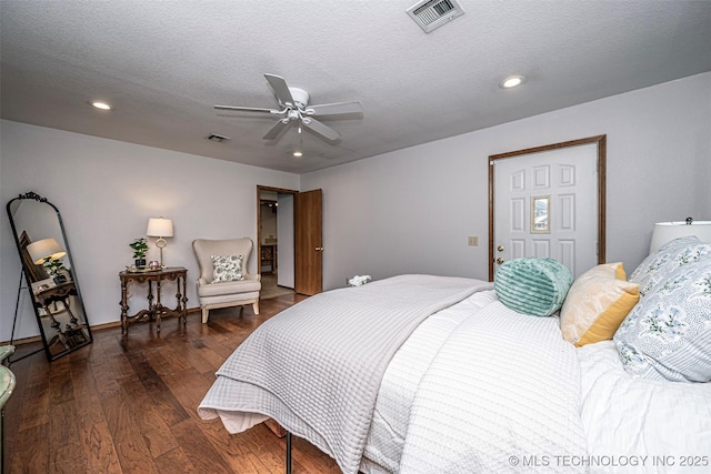 bedroom with recessed lighting, wood finished floors, visible vents, and a textured ceiling