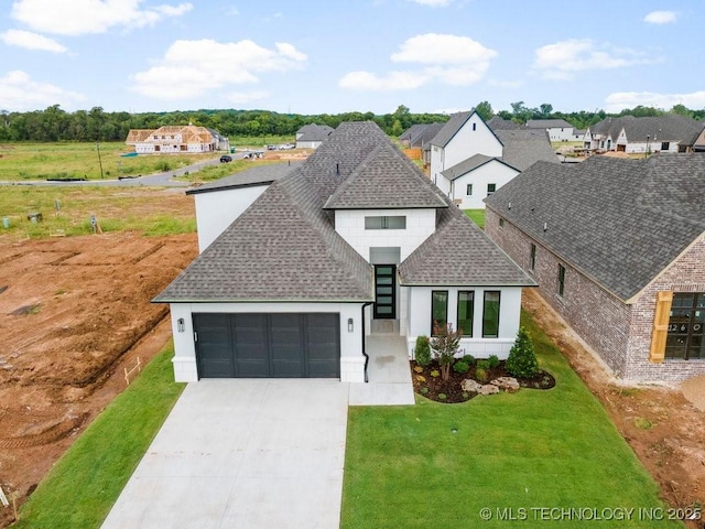 view of front of property with a front yard, an attached garage, driveway, and roof with shingles