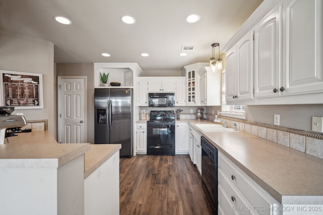 kitchen with visible vents, dark wood-type flooring, recessed lighting, black appliances, and a sink