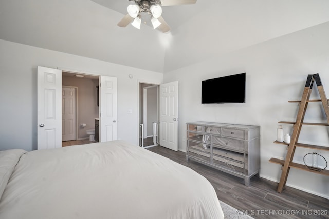 bedroom with ceiling fan, baseboards, vaulted ceiling, ensuite bathroom, and wood finished floors