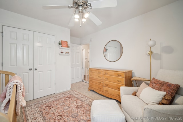 bedroom featuring baseboards, a ceiling fan, a closet, and light carpet