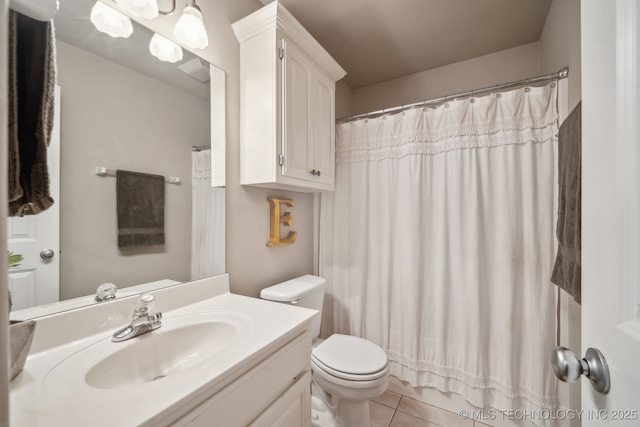 bathroom featuring curtained shower, toilet, vanity, and tile patterned flooring