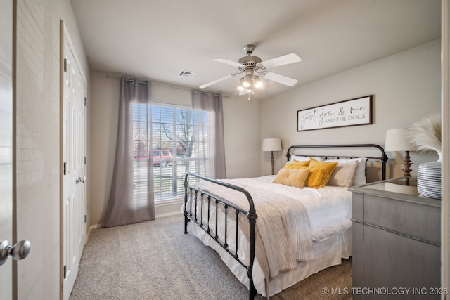 carpeted bedroom featuring visible vents, baseboards, and ceiling fan