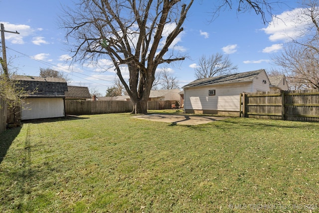 2503 S Pittsburg Ave, Tulsa, OK 74114 - view of yard with a patio area, a fenced backyard, an outdoor structure, and a storage unit