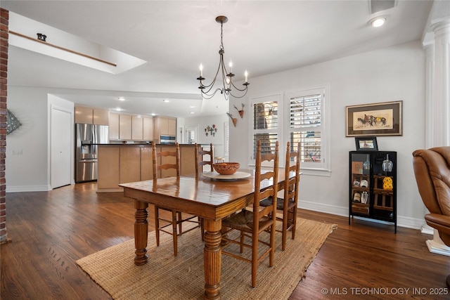 dining area featuring dark wood-type flooring, baseboards, recessed lighting, a skylight, and an inviting chandelier