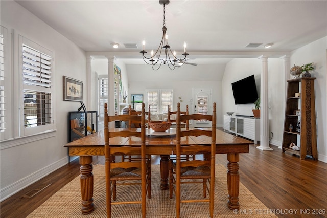 dining area with visible vents, dark wood-type flooring, and decorative columns