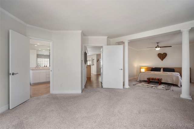 bedroom with light colored carpet, baseboards, crown molding, and ornate columns