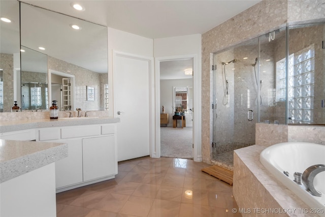 full bathroom featuring tile patterned floors, a stall shower, recessed lighting, a bath, and vanity