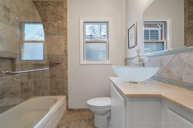 full bath featuring decorative backsplash, toilet, and vanity