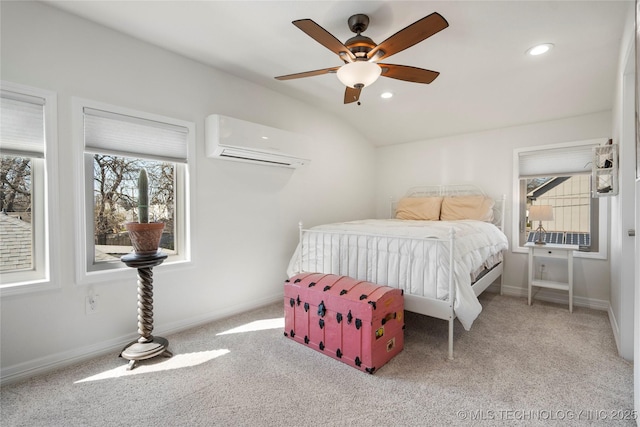 bedroom featuring baseboards, lofted ceiling, carpet floors, and a wall unit AC