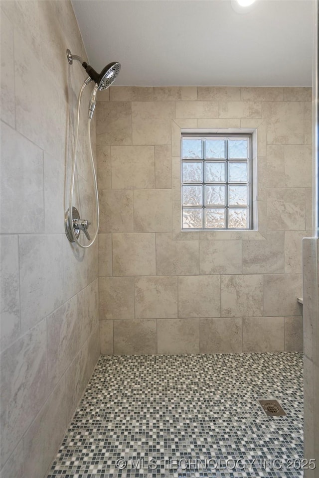 full bathroom with tiled shower