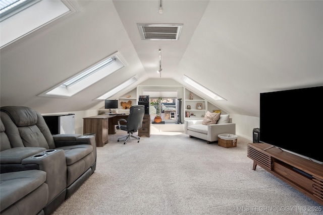 office area featuring built in features, visible vents, carpet floors, and lofted ceiling with skylight