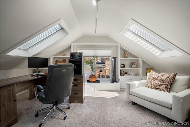 carpeted office space with lofted ceiling with skylight