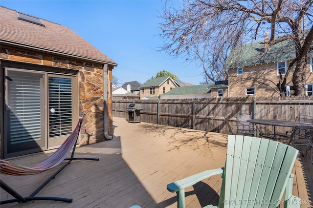 deck with a fenced backyard and grilling area