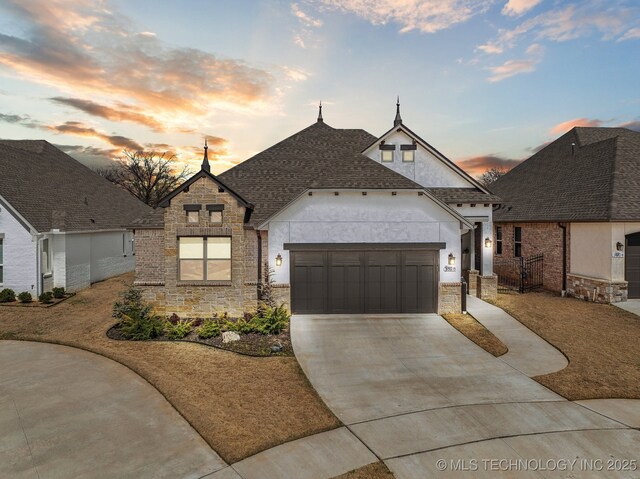 3828 W Orlando St, Broken Arrow, OK 74011 - french country style house featuring stone siding, a garage, concrete driveway, roof with shingles, and stucco siding
