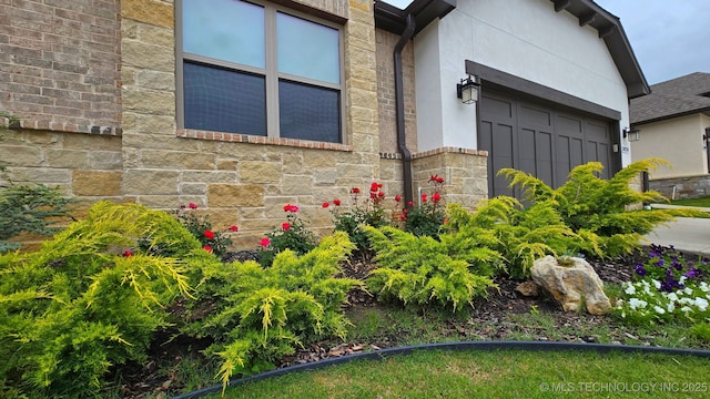 3828 W Orlando St, Broken Arrow, OK 74011 - view of property exterior with stone siding, a garage, and stucco siding