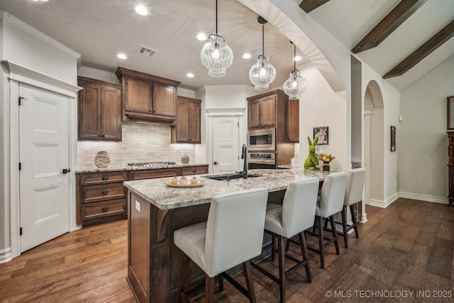 3828 W Orlando St, Broken Arrow, OK 74011 - kitchen featuring a sink, stainless steel appliances, decorative backsplash, a kitchen bar, and recessed lighting