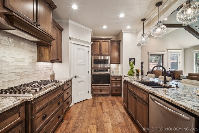 3828 W Orlando St, Broken Arrow, OK 74011 - kitchen with stainless steel appliances, a sink, open floor plan, backsplash, and light stone counters